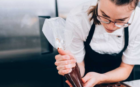 A woman using a piping bag